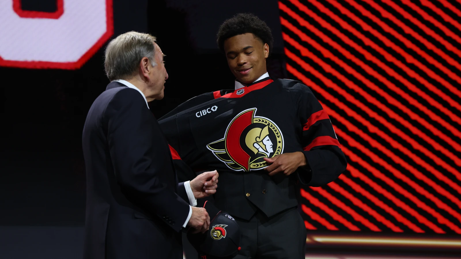 Jaxon Cover reacts beside NHL commissioner Gary Bettman after the Ottawa Senators selected Cover 32nd overall at the 2026 NHL Draft in Buffalo. File photo.