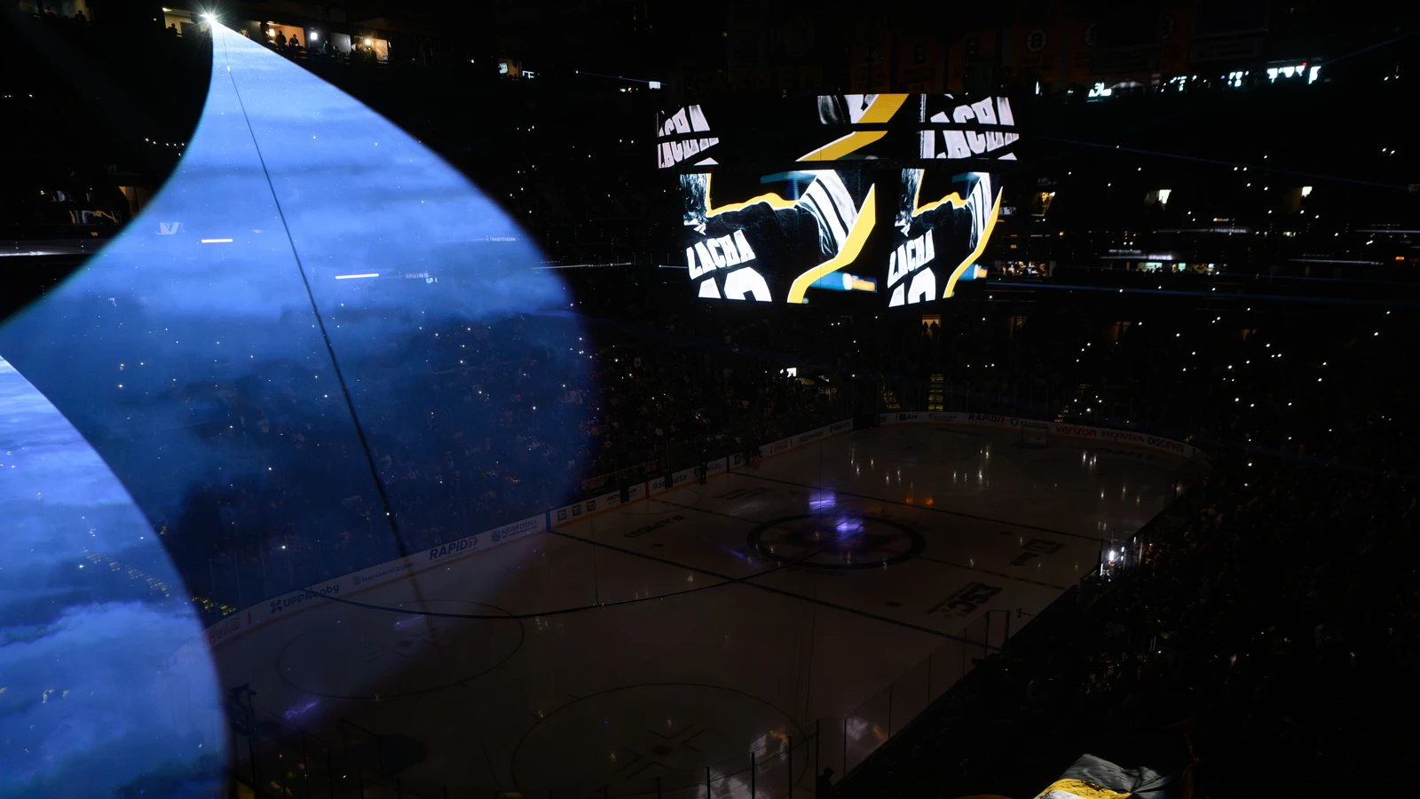 File photo: Blue spotlights illuminate the rink and scoreboard at TD Garden before a Boston Bruins playoff game.