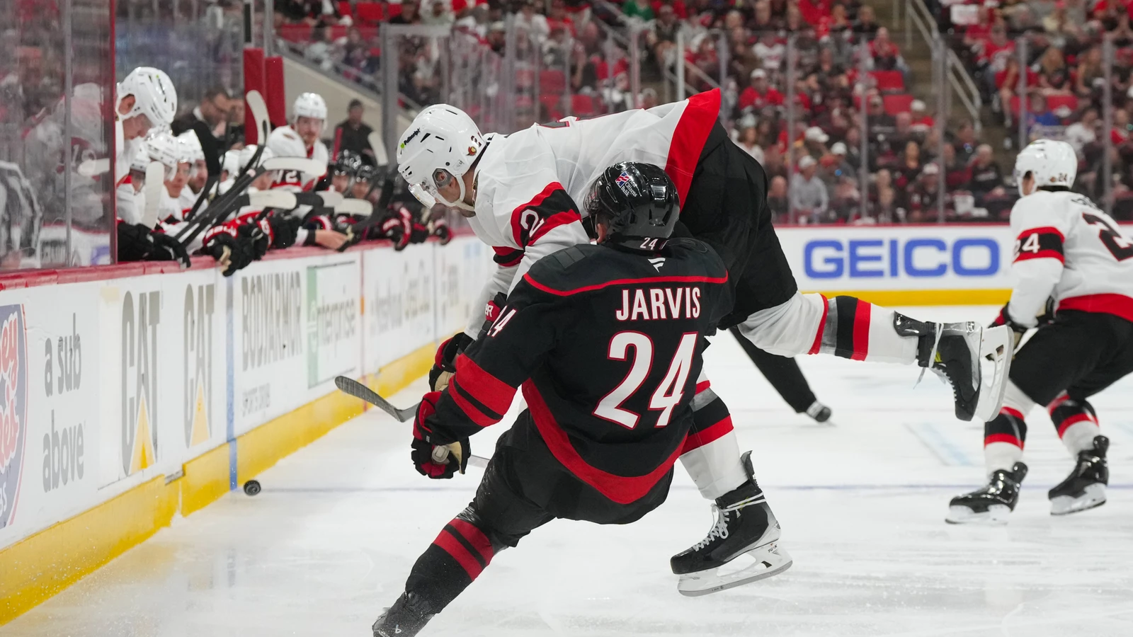 Artem Zub checks Seth Jarvis during Ottawa's playoff game at Carolina on April 18, 2026. File photo.