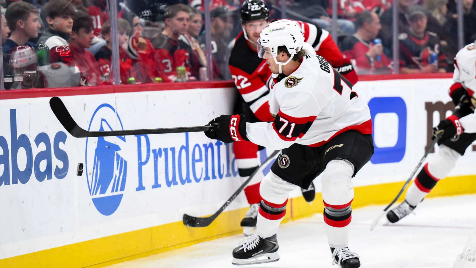 File photo: Ottawa Senators forward Ridly Greig controls the puck with New Jersey Devils defenceman Brett Pesce trailing him.