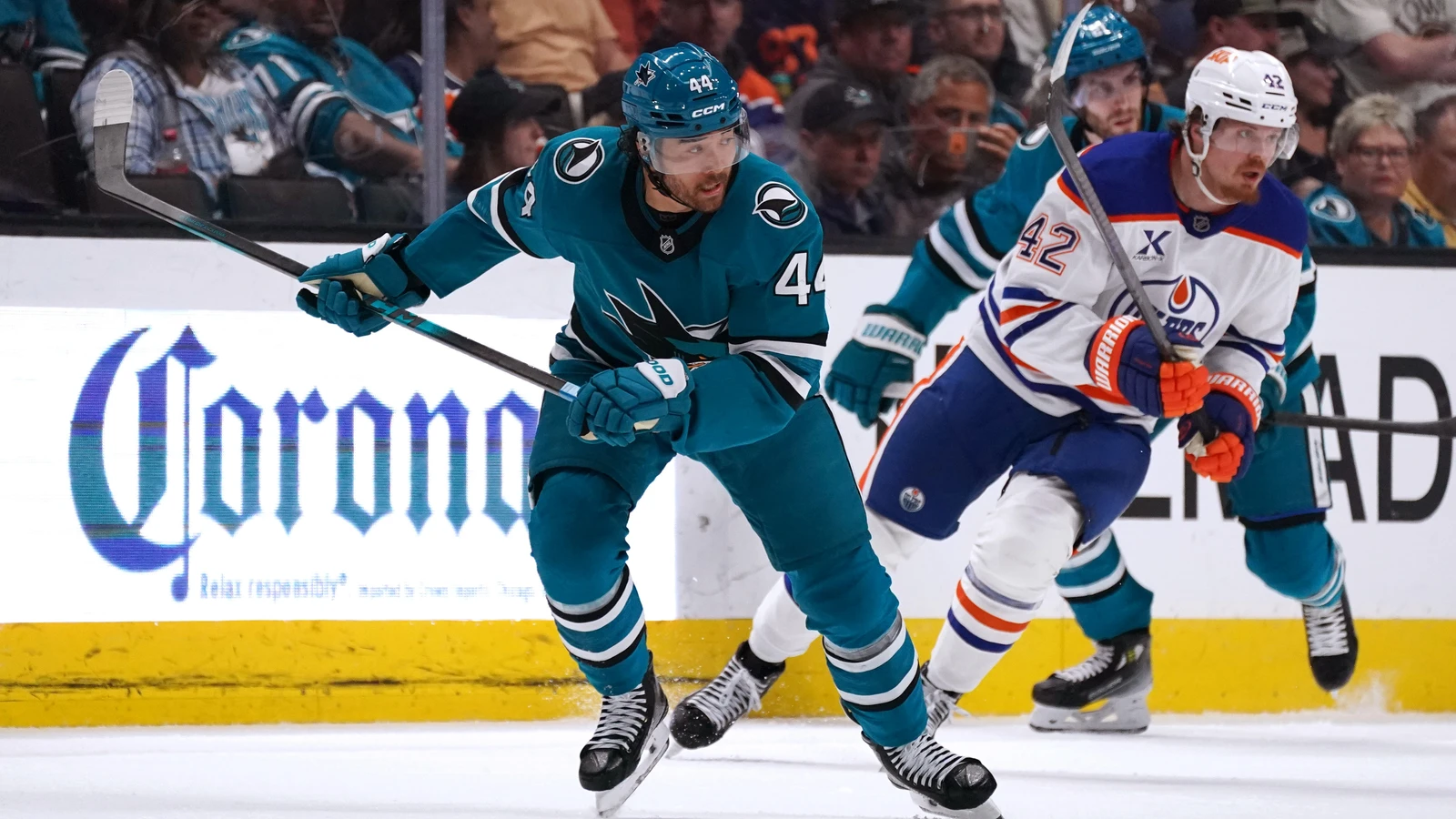 San Jose Sharks winger Kiefer Sherwood races Edmonton Oilers winger Kasperi Kapanen toward the puck at SAP Center on April 8, 2026. File photo.
