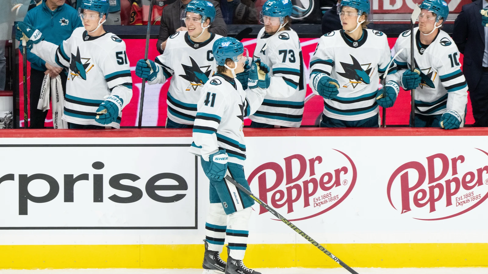 File photo: San Jose Sharks players celebrate a goal at their bench during a game in Ottawa.