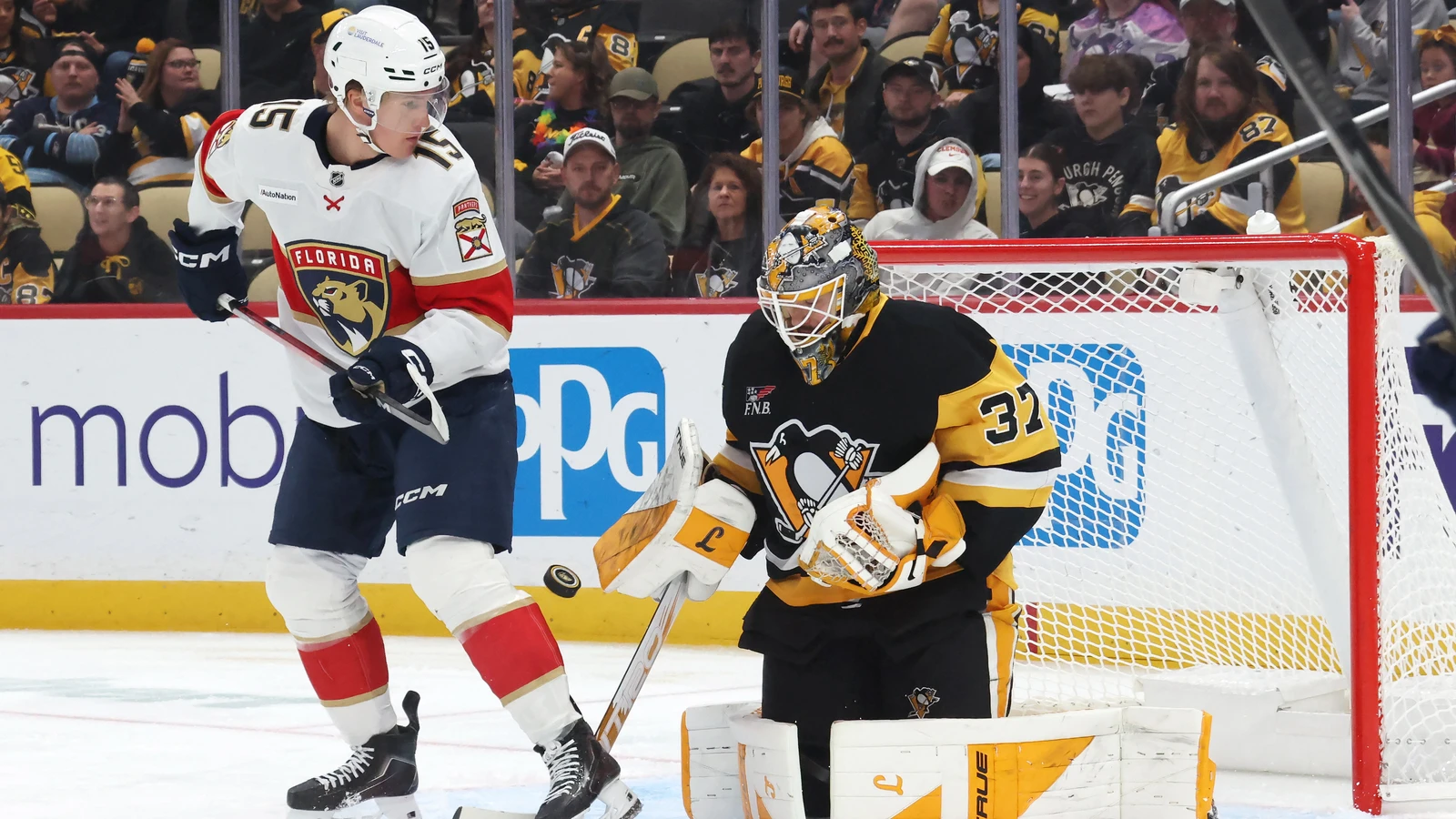 Pittsburgh Penguins goaltender Arturs Silovs makes a save behind Florida Panthers forward Anton Lundell at PPG Paints Arena.