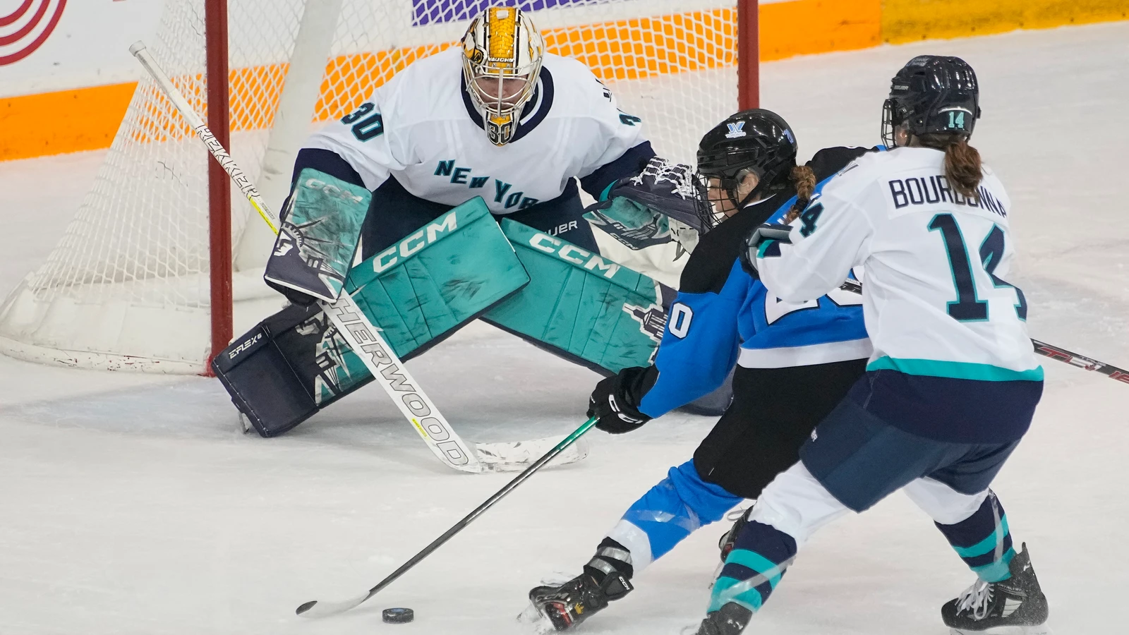 New York defender Jaime Bourbonnais, number 14, chases Toronto forward Sarah Nurse as Corinne Schroeder prepares to make a save during the inaugural PWHL game on January 1, 2024. File photo; this is game action, not the 2026 Colorado practice or youth clinic.