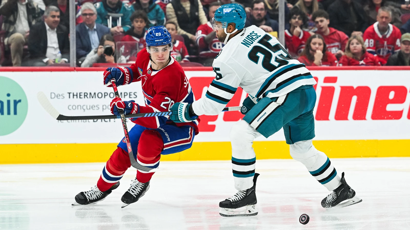 Juraj Slafkovský carries the puck past Darnell Nurse during the second period at Bell Centre.