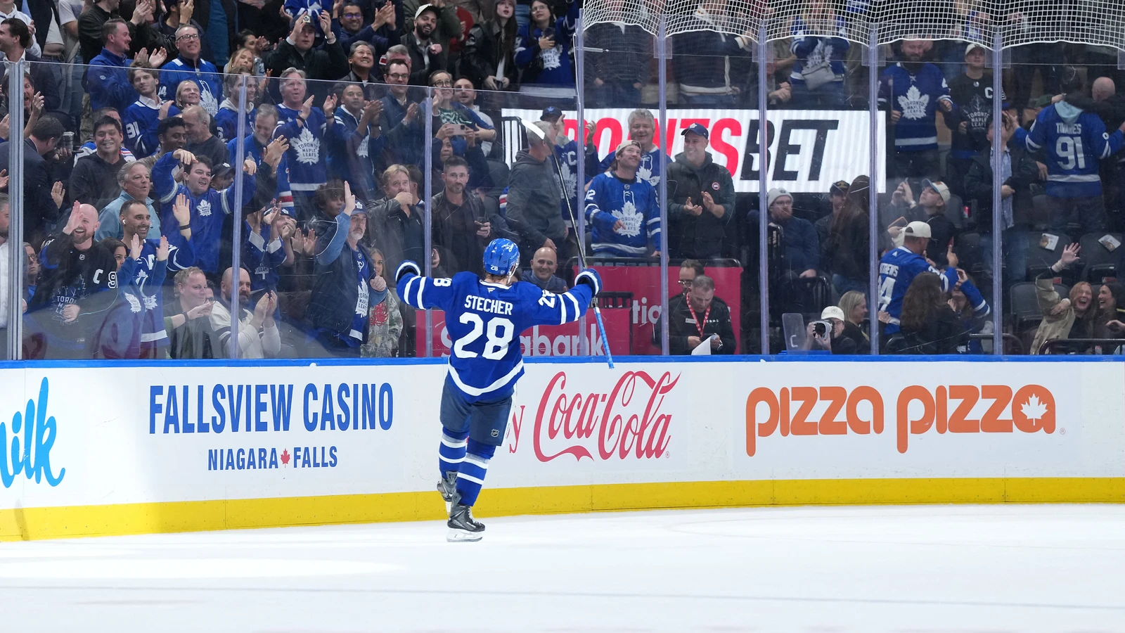 Troy Stecher raises his arms after scoring the winning goal for Toronto against the New York Rangers at Scotiabank Arena.