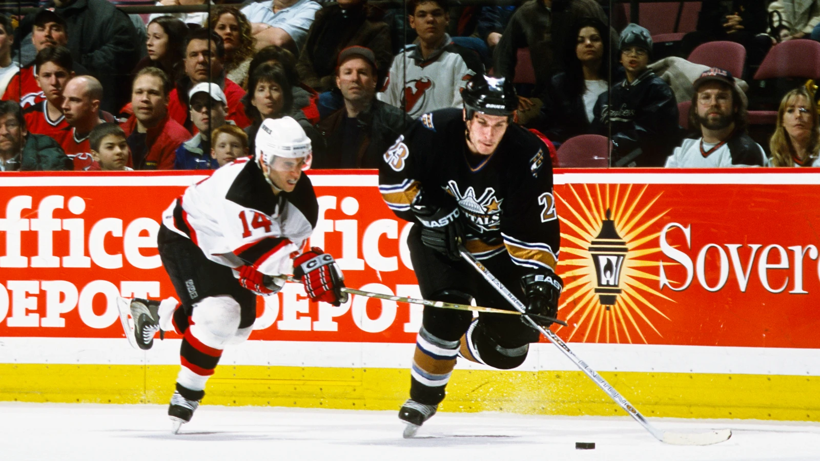 Washington Capitals center Trent Whitfield, right, skates against New Jersey Devils right wing Brian Gionta on December 28, 2002. File photo.