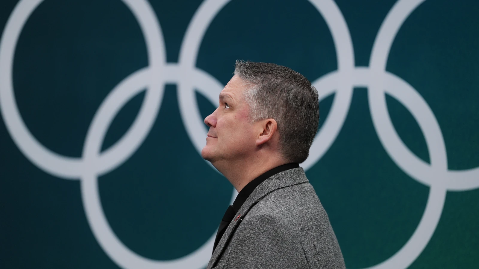 Canada head coach Troy Ryan walks back to the ice between periods against the United States during the 2026 Olympic women’s hockey tournament in Milan. File photo; this is not PWHL San Jose’s debut or game action.