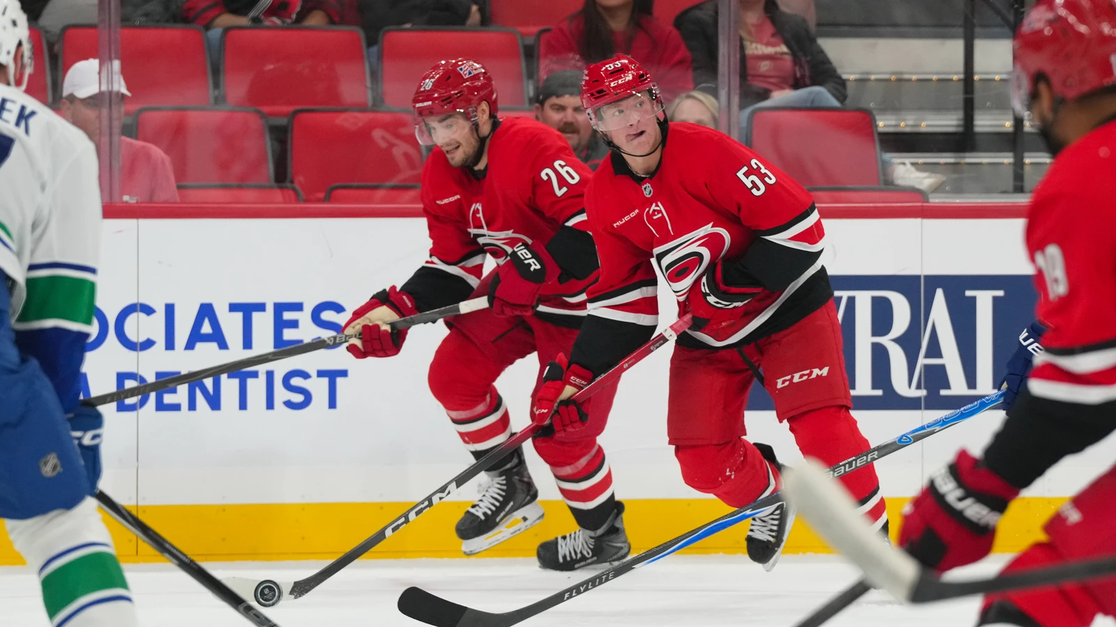Sean Walker (26) skates alongside a Carolina Hurricanes teammate against the Vancouver Canucks.