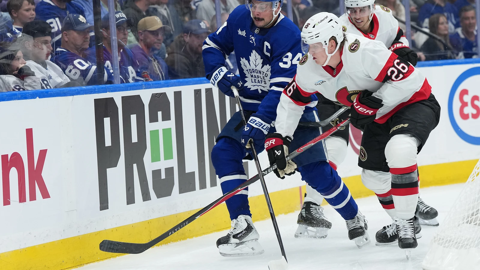 File photo: Carter Yakemchuk battles for the puck with Toronto Maple Leafs captain Auston Matthews.
