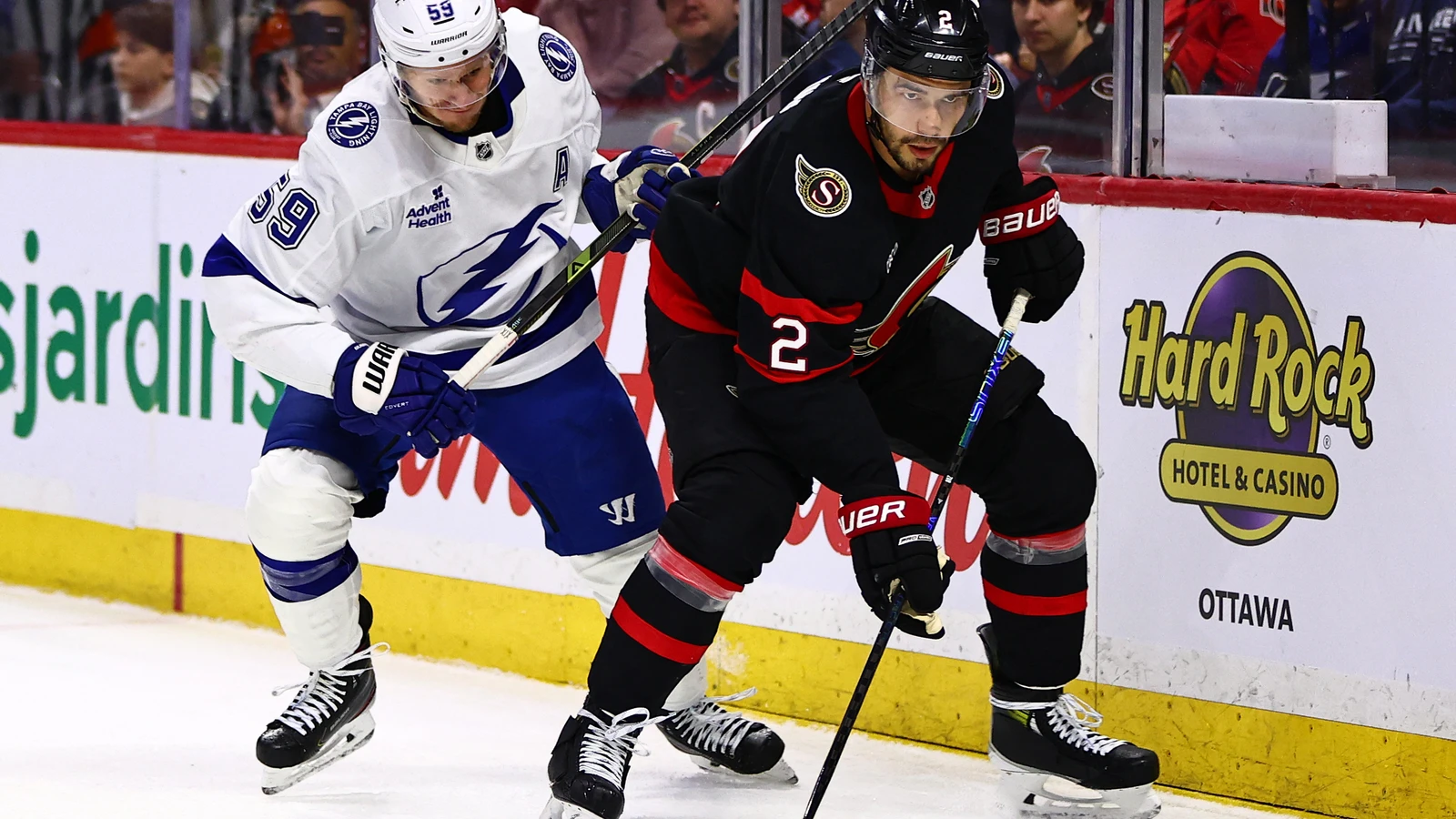 File photo: Ottawa Senators defenceman Artem Zub (2) controls the puck as Tampa Bay Lightning forward Jake Guentzel challenges him during an Apr. 7, 2026 game in Ottawa.